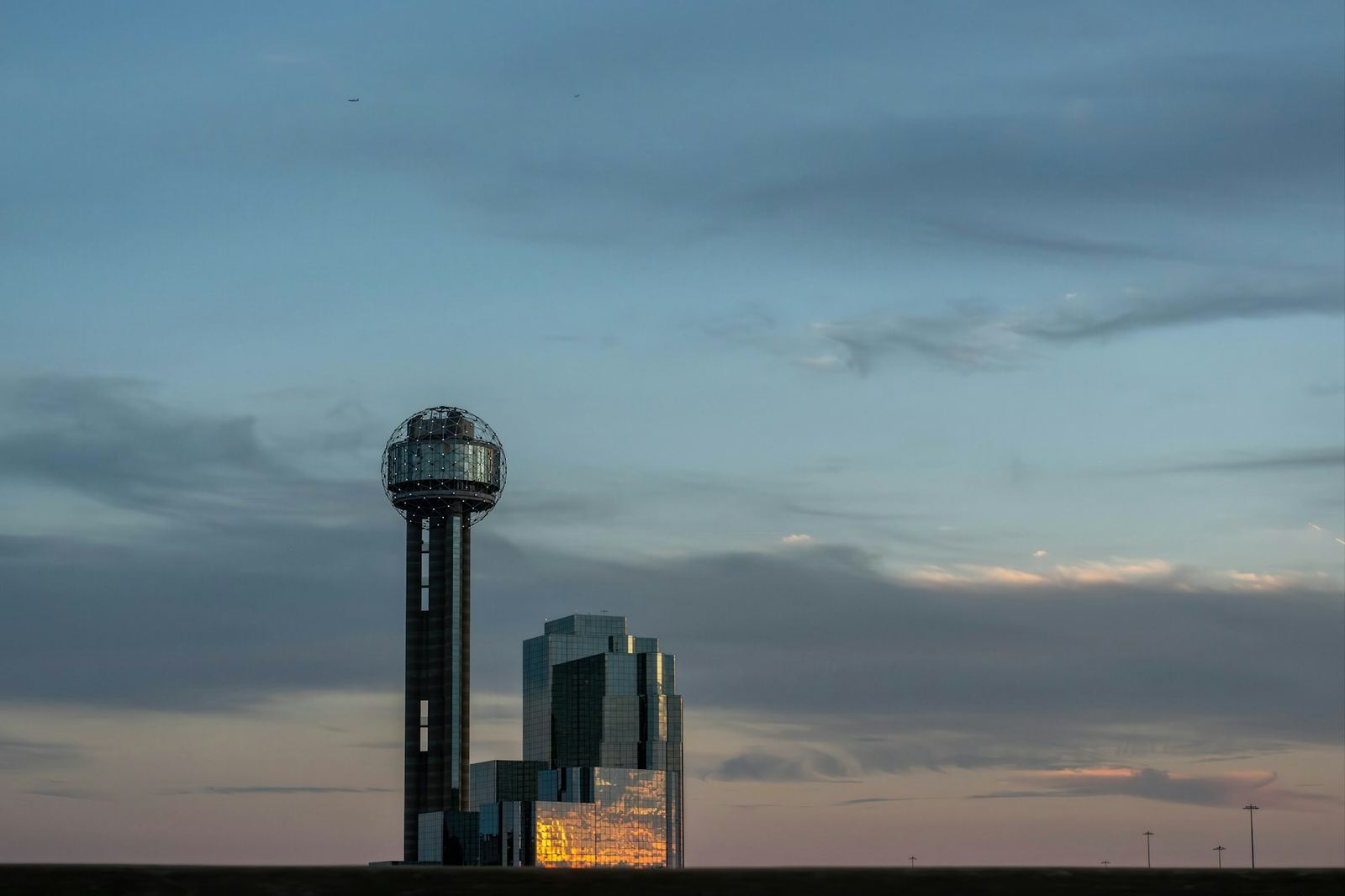 Reunion Tower and the Dallas skyline beneath a wide evening sky